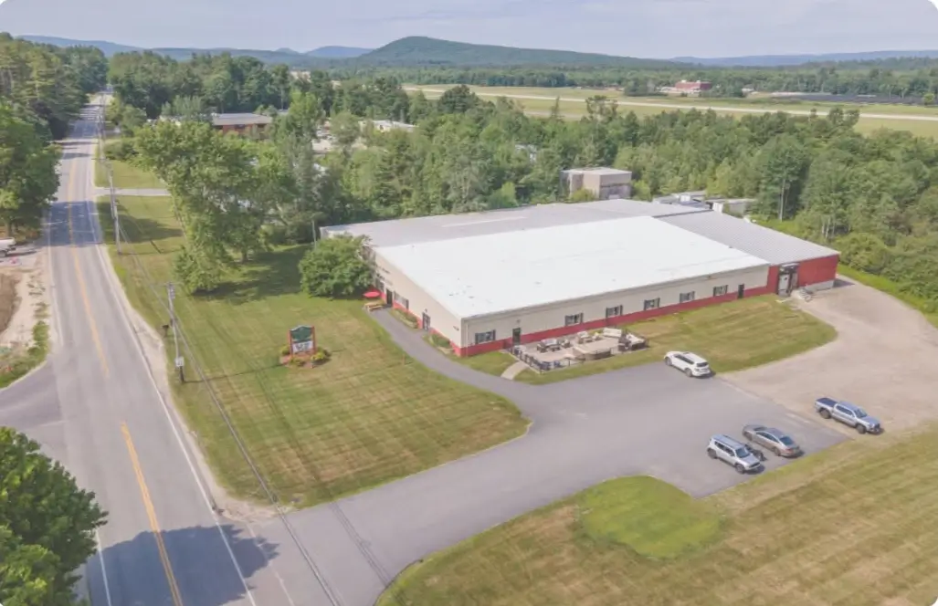 Aerial view of a commercial building near a runway.