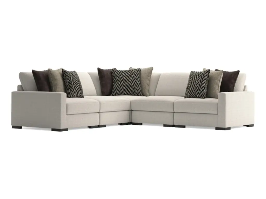 L-shaped off-white modular sectional sofa with decorative accent pillows.